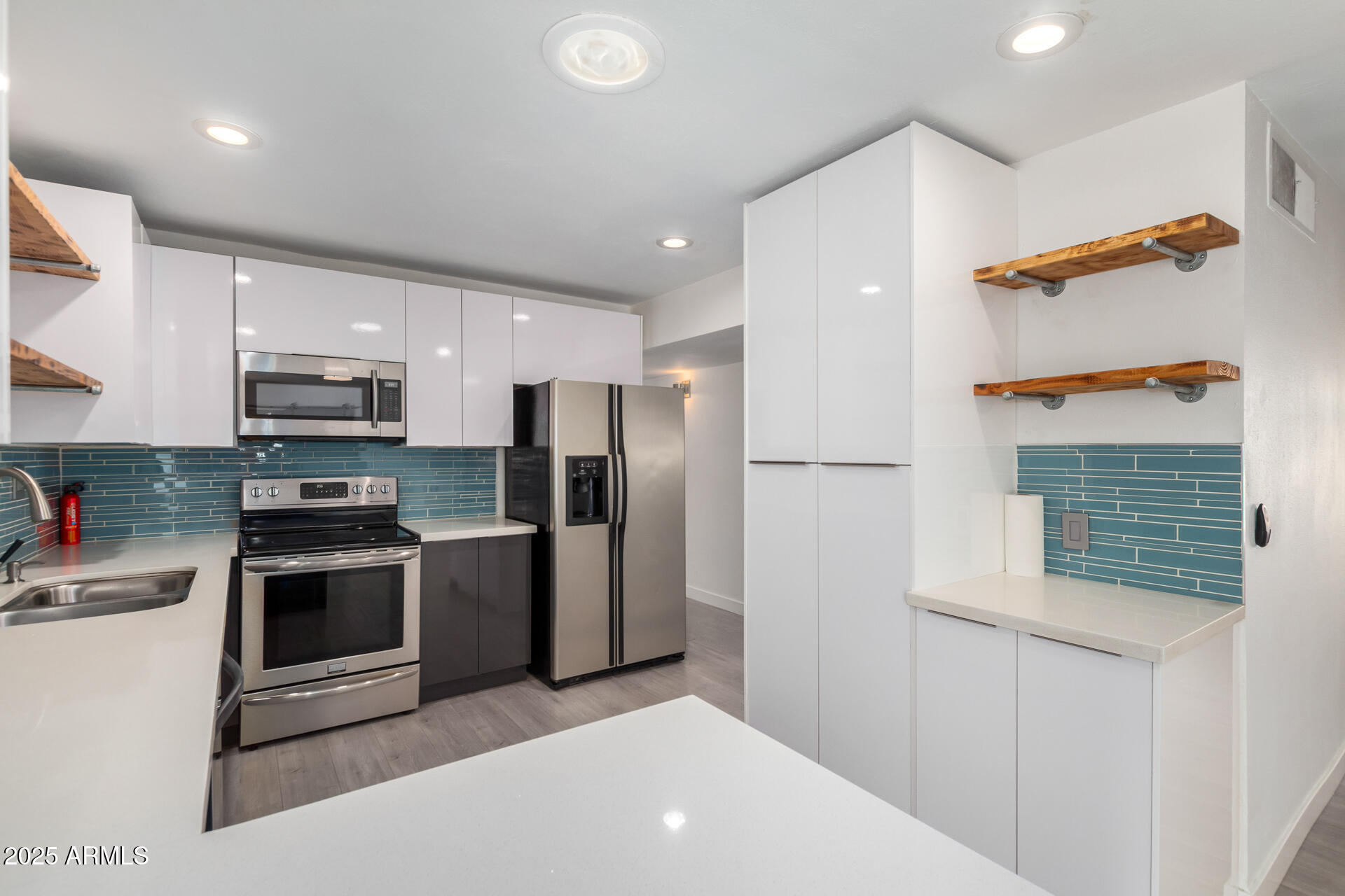 3329 East Palm Lane Phoenix, AZ 85008 - Photo 11 of 45 a kitchen with stainless steel appliances granite countertop a refrigerator and a sink