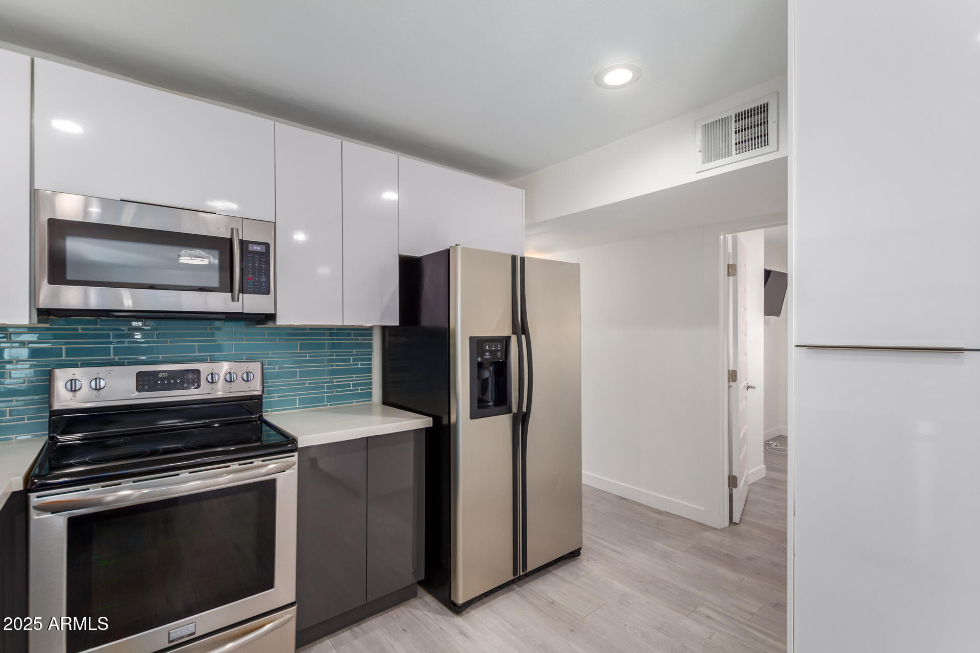 3329 East Palm Lane Phoenix, AZ 85008 - Photo 14 of 45 a kitchen with stainless steel appliances a refrigerator stove and microwave