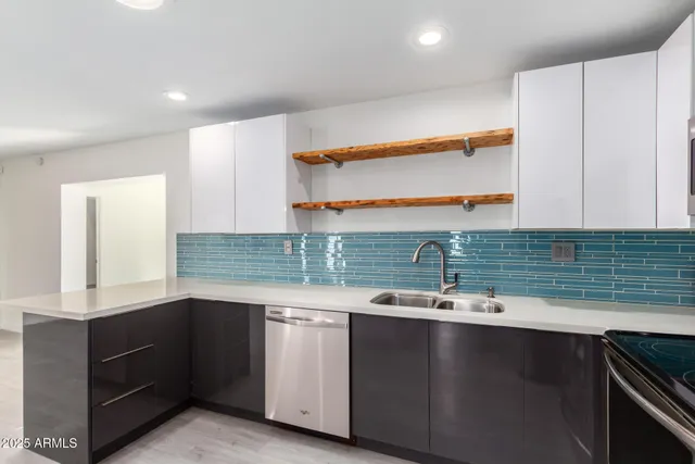 a kitchen with granite countertop a sink and a stove