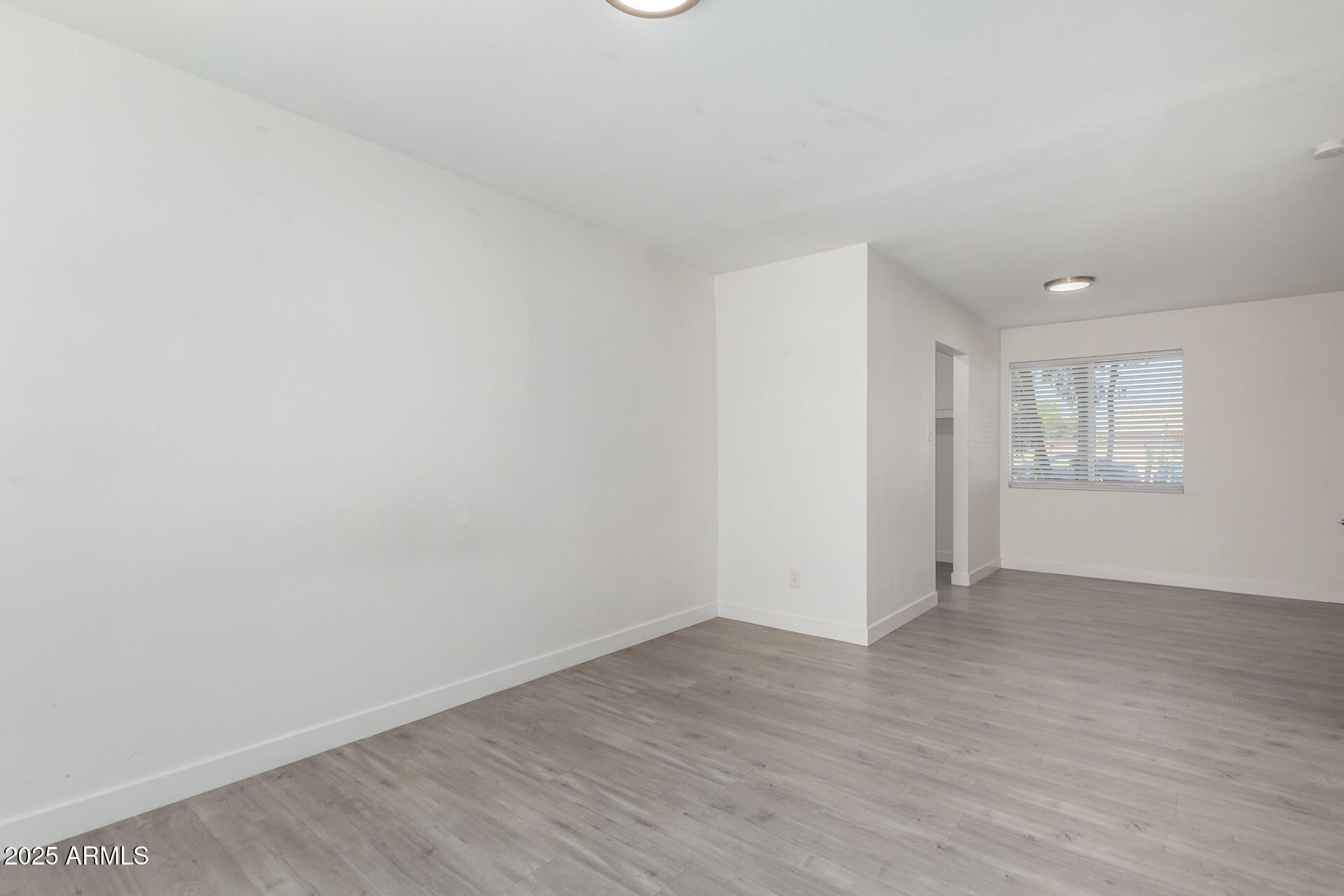 3329 East Palm Lane Phoenix, AZ 85008 - Photo 18 of 45 an empty room with wooden floor and windows