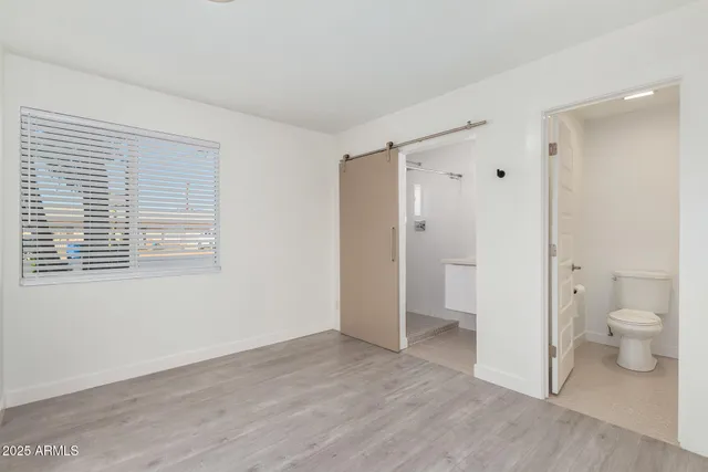 a bathroom view of a toilet and a shower