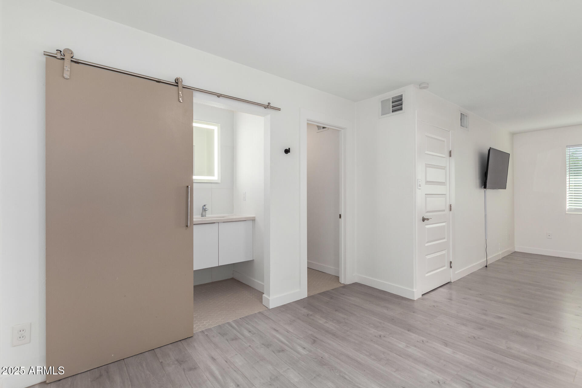 3329 East Palm Lane Phoenix, AZ 85008 - Photo 21 of 45 a view of an empty room and wooden floor