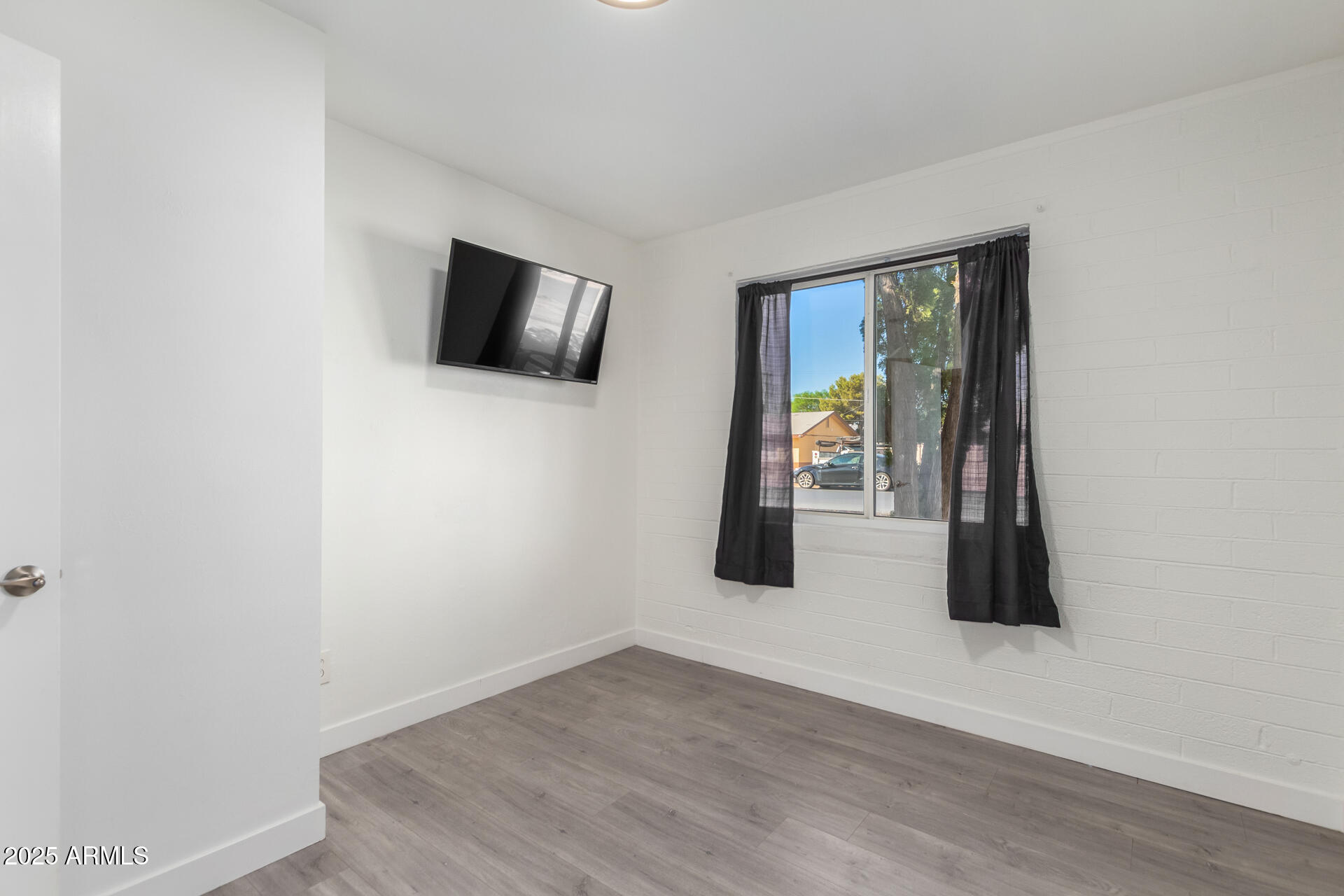 3329 East Palm Lane Phoenix, AZ 85008 - Photo 26 of 45 a view of an empty room with wooden floor and windows