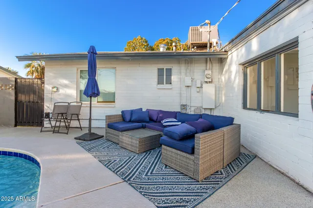 a view of a backyard with swimming pool