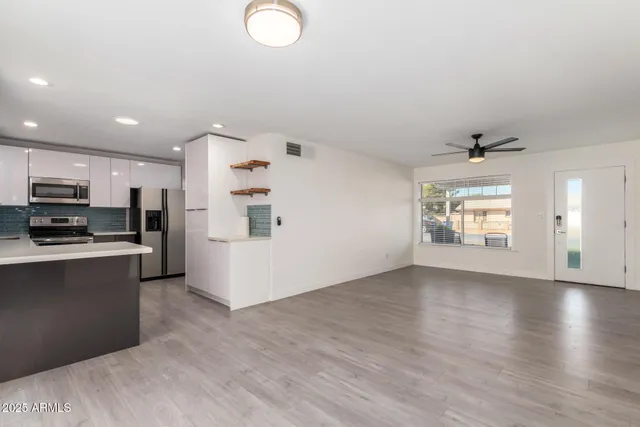 a view of kitchen with furniture and wooden floor