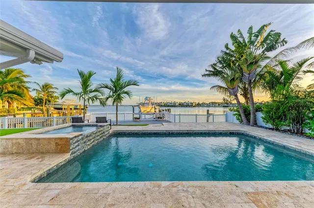 a large kitchen with stainless steel appliances granite countertop a stove and a dining table view
