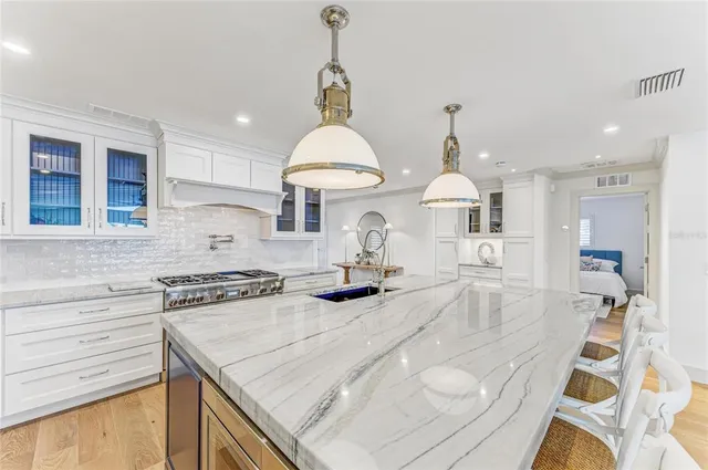 a bedroom with furniture and a large window