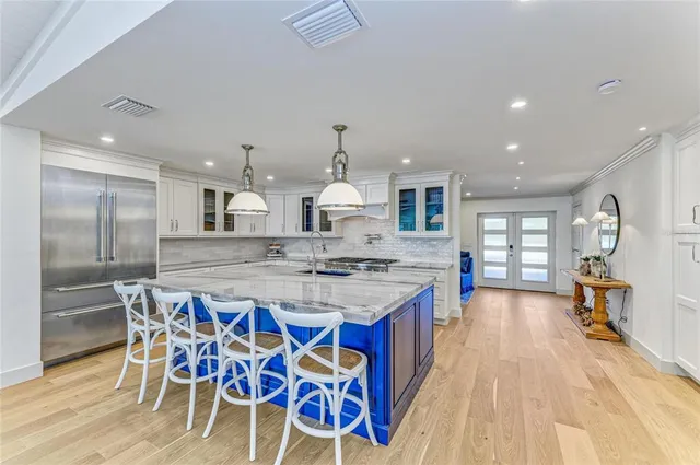 a spacious bathroom with a tub sink and mirror