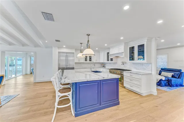 a spacious bathroom with a double vanity sink a large mirror and a bathtub