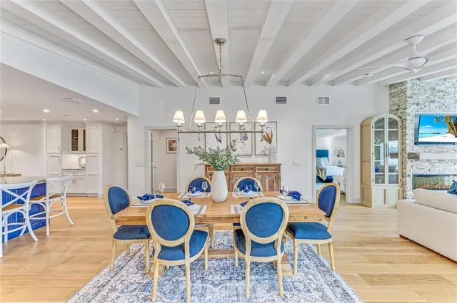 a view of a livingroom with furniture fridge and wooden floor