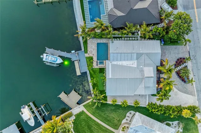 a living room with furniture a mirror and glass table