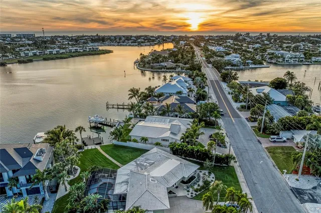 a kitchen with a stove a sink a dining table and chairs