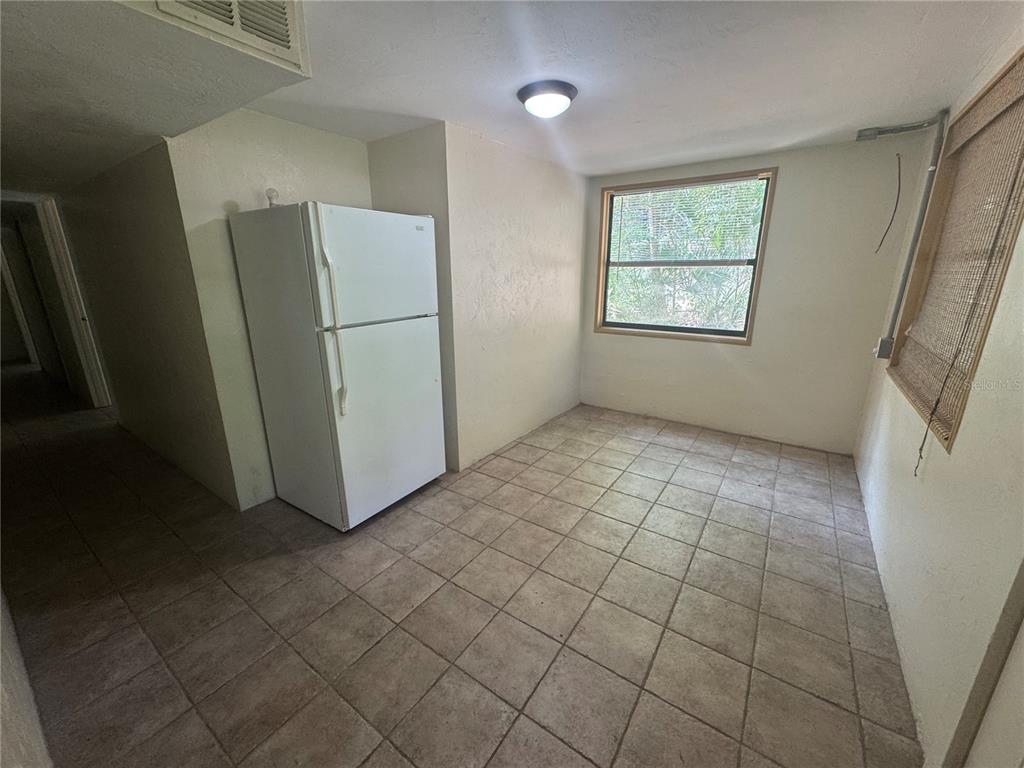 3 Northwest 24 Street Gainesville, FL 32607 - Photo 11 of 22 an empty room with a wooden floor and a window