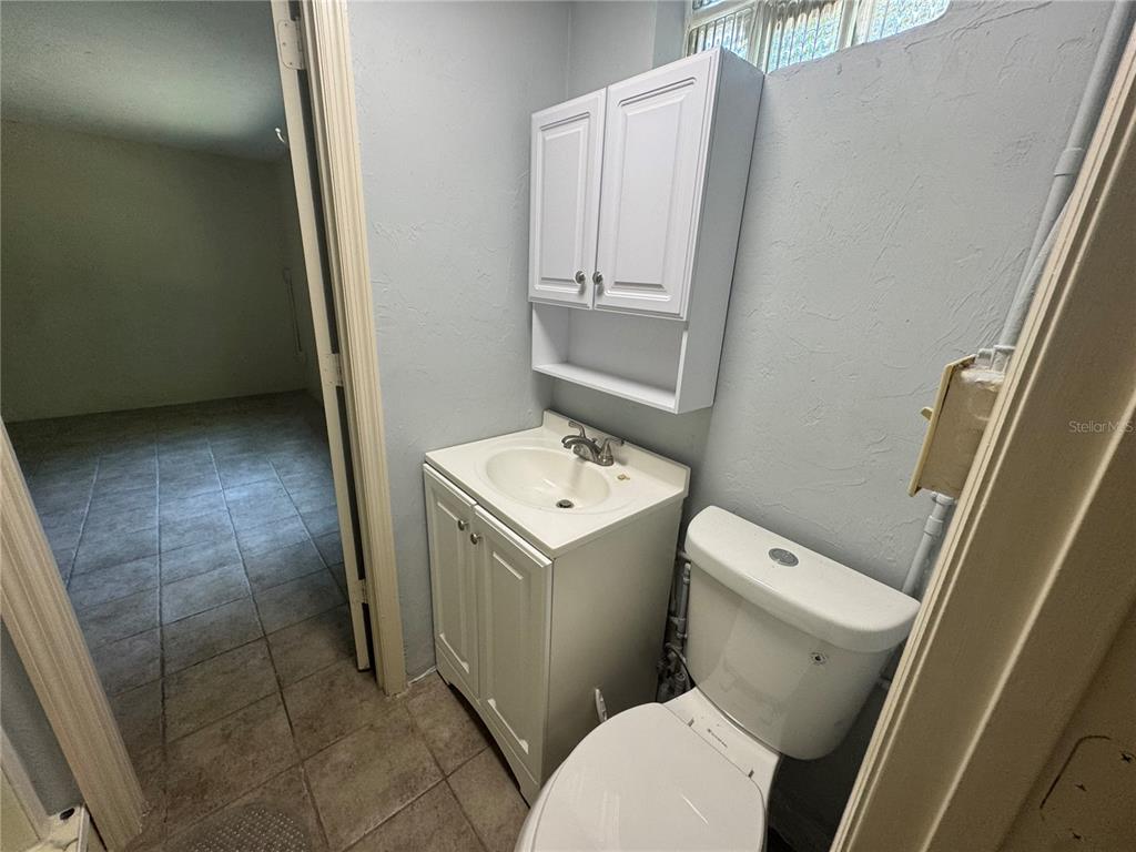 3 Northwest 24 Street Gainesville, FL 32607 - Photo 15 of 22 a white toilet sitting next to a white sink and vanity