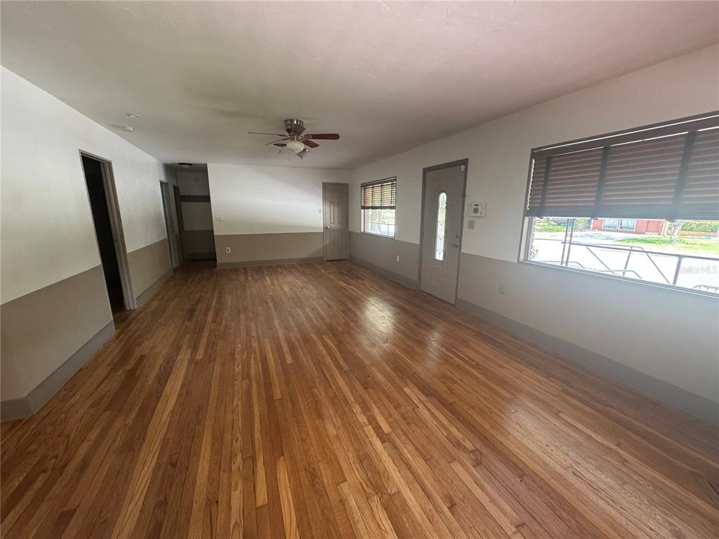 3 Northwest 24 Street Gainesville, FL 32607 - Photo 2 of 22 wooden floor in an empty room with a window