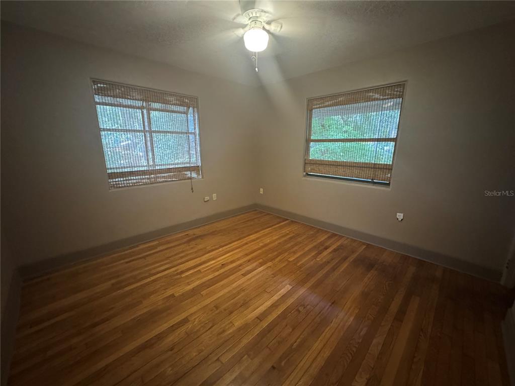 3 Northwest 24 Street Gainesville, FL 32607 - Photo 9 of 22 an empty room with wooden floor and windows