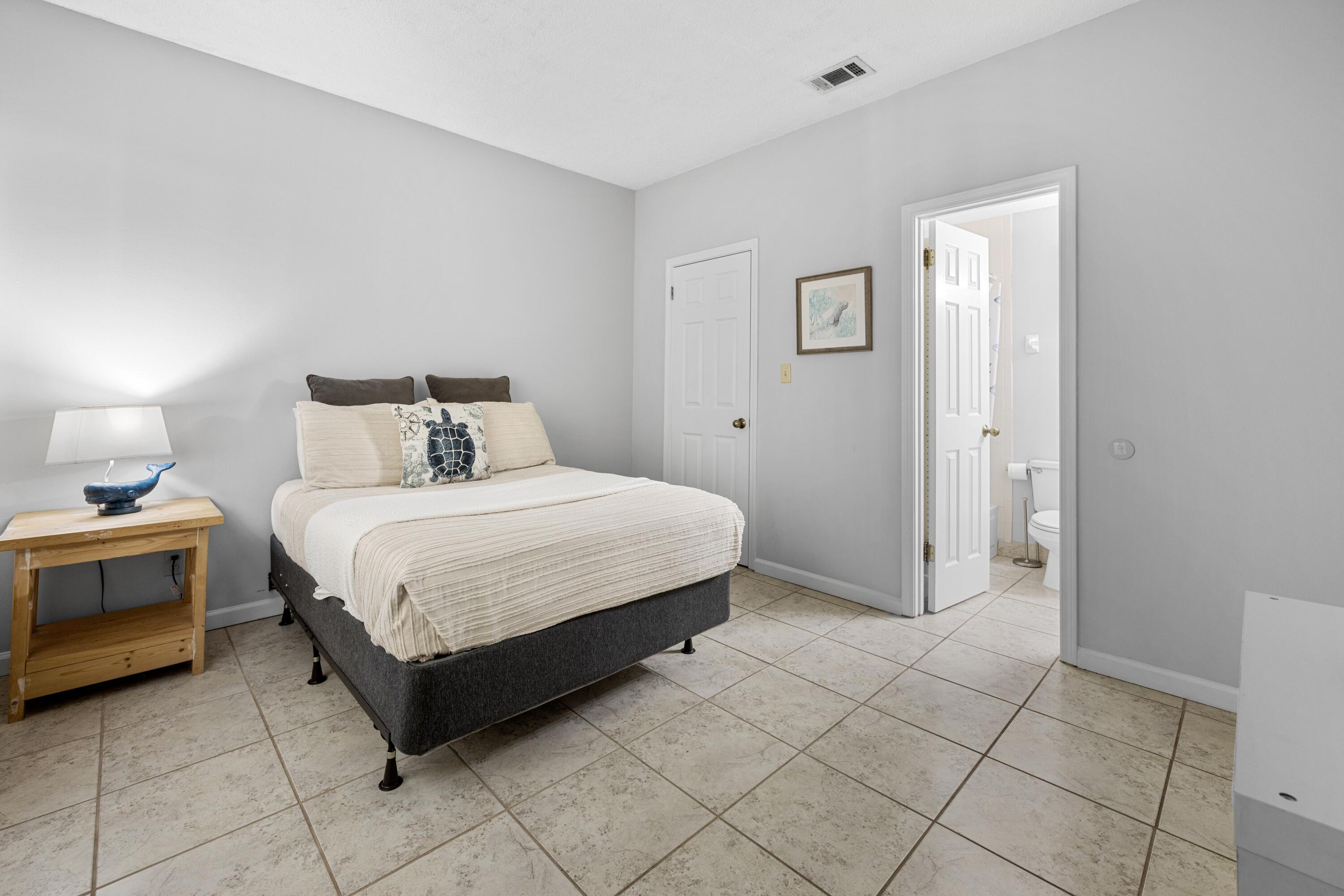 200 Sandestin Lane, Unit 1209 Miramar Beach, FL 32550 - Photo 14 of 30 a bedroom with a bed and a table