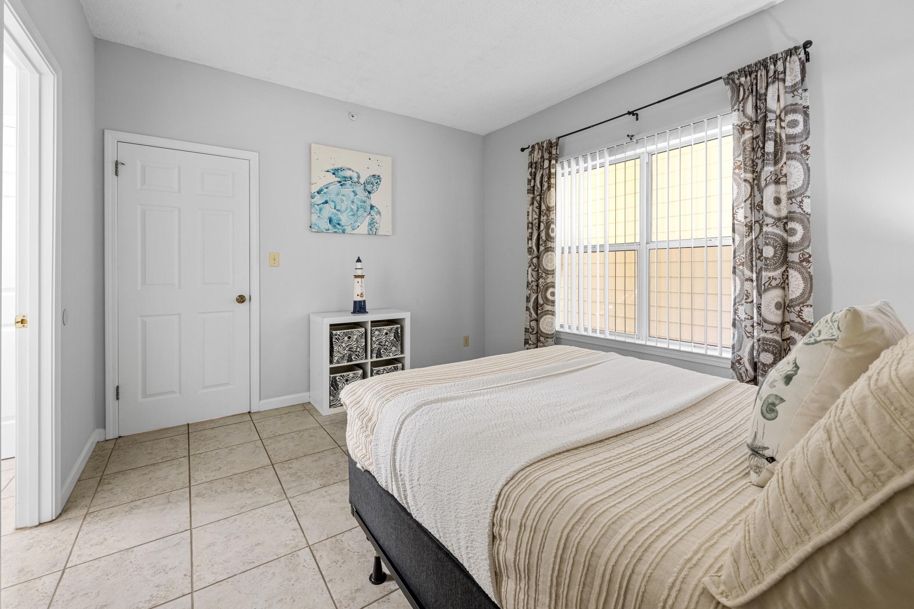 200 Sandestin Lane, Unit 1209 Miramar Beach, FL 32550 - Photo 15 of 30 a bedroom with a bed and a window