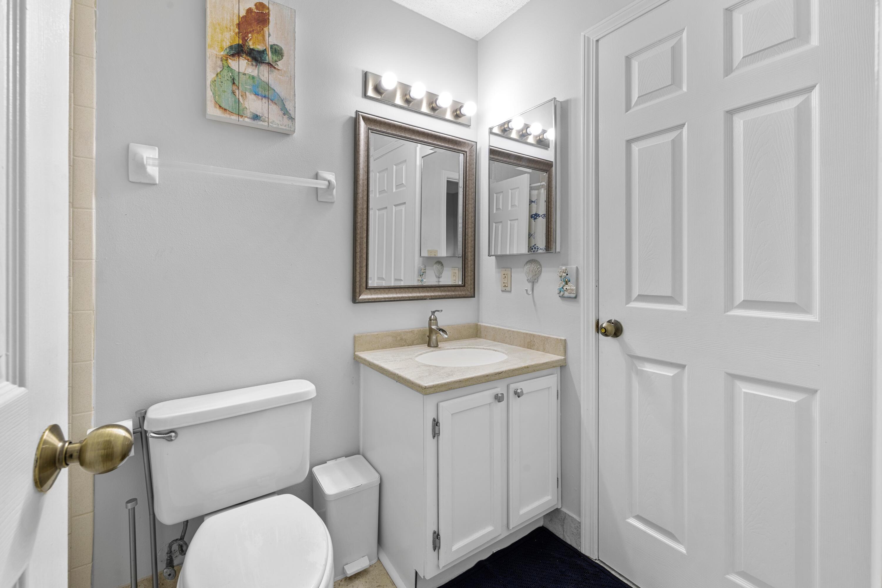 200 Sandestin Lane, Unit 1209 Miramar Beach, FL 32550 - Photo 16 of 30 a bathroom with a toilet a sink and mirror