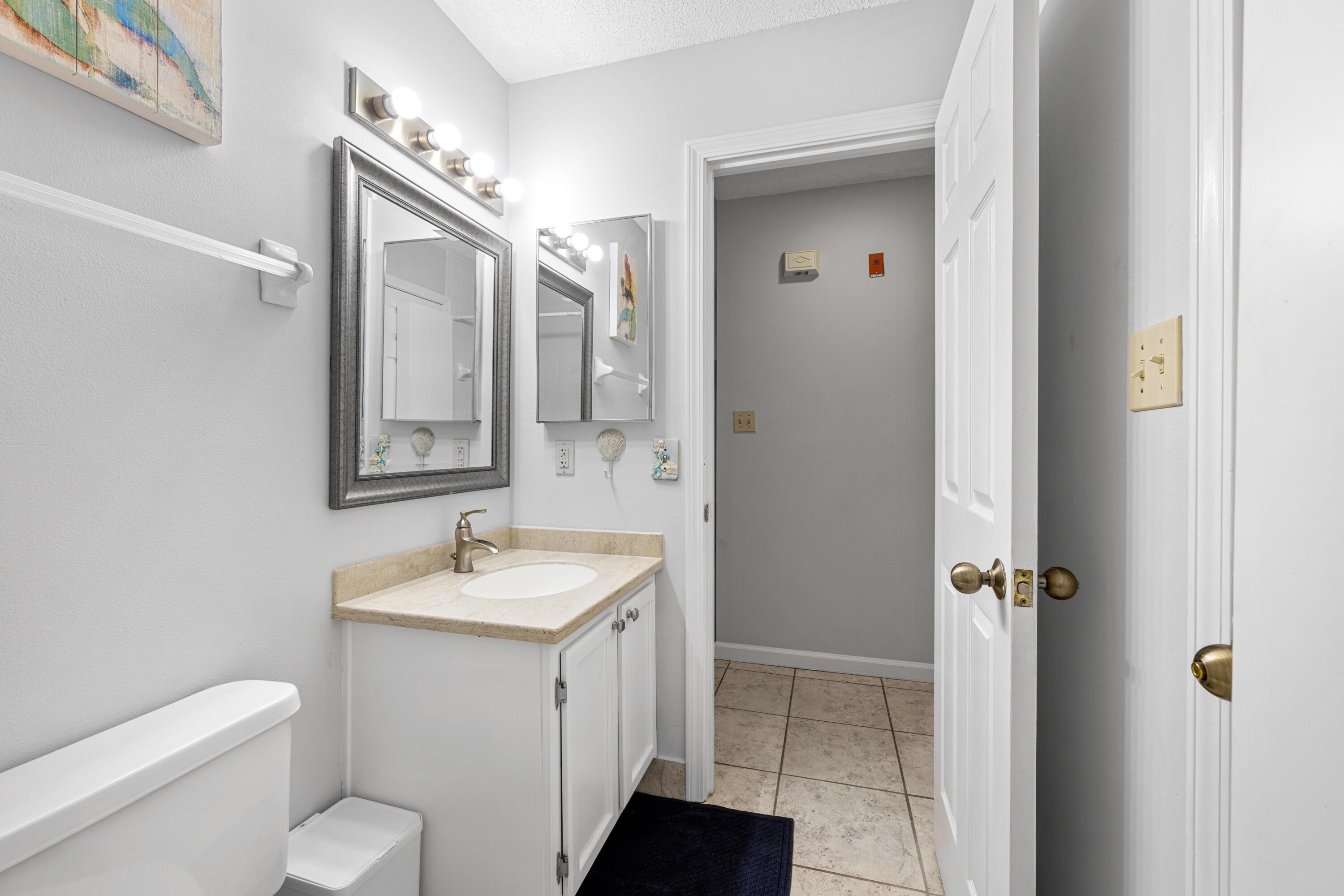 200 Sandestin Lane, Unit 1209 Miramar Beach, FL 32550 - Photo 18 of 30 a bathroom with a granite countertop sink toilet and shower