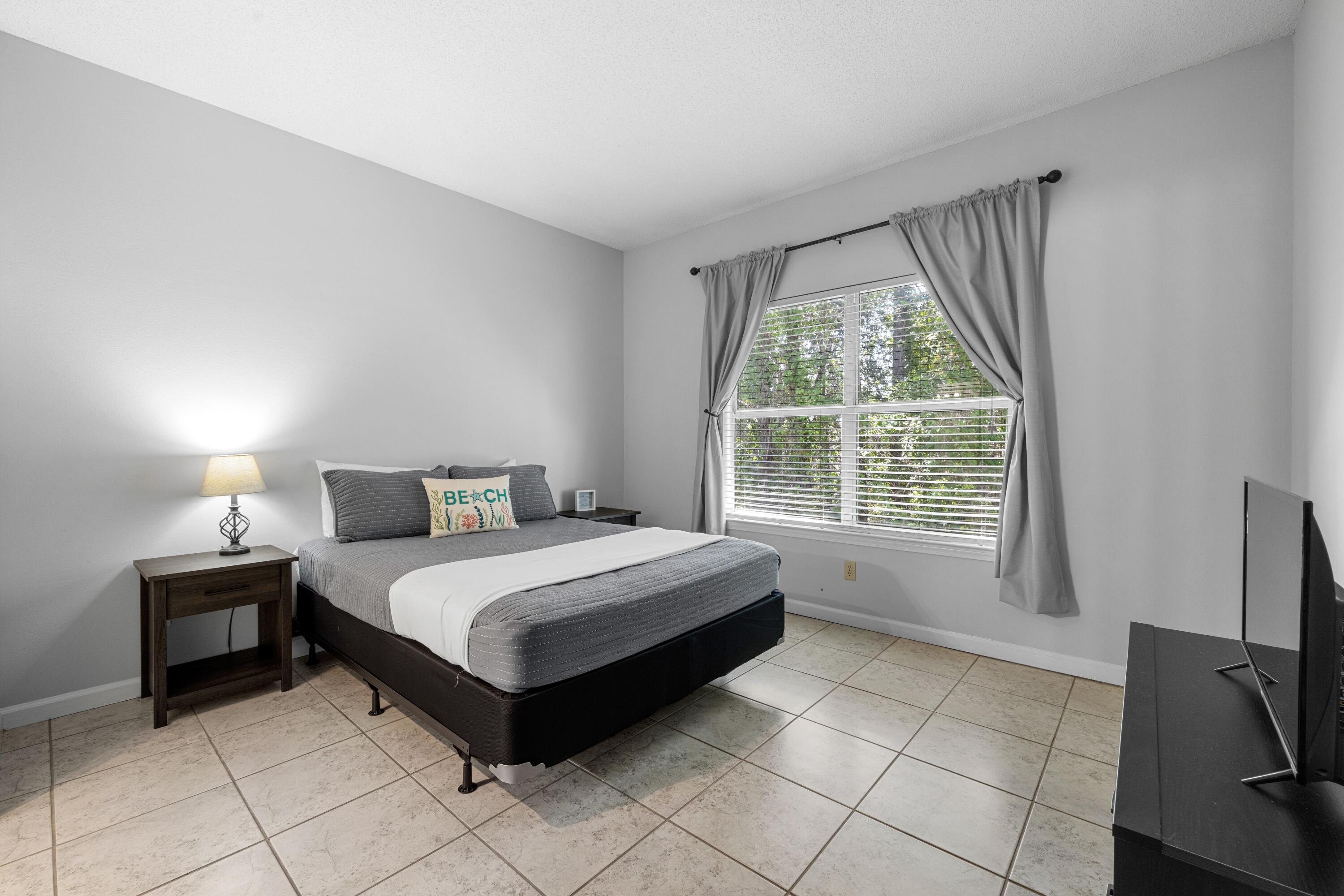 200 Sandestin Lane, Unit 1209 Miramar Beach, FL 32550 - Photo 19 of 30 a bedroom with a bed and a television