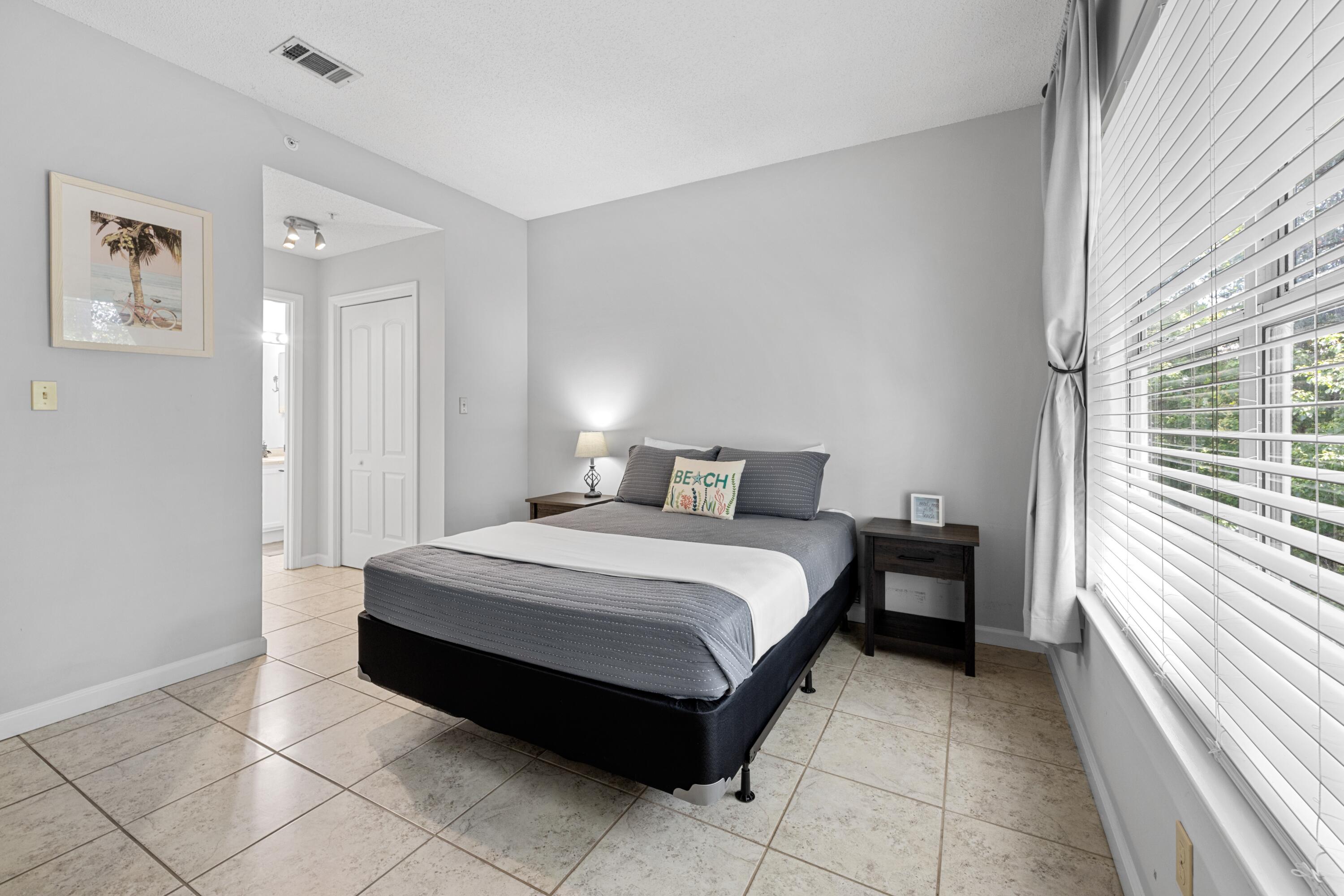 200 Sandestin Lane, Unit 1209 Miramar Beach, FL 32550 - Photo 20 of 30 a spacious bedroom with a bed and a window