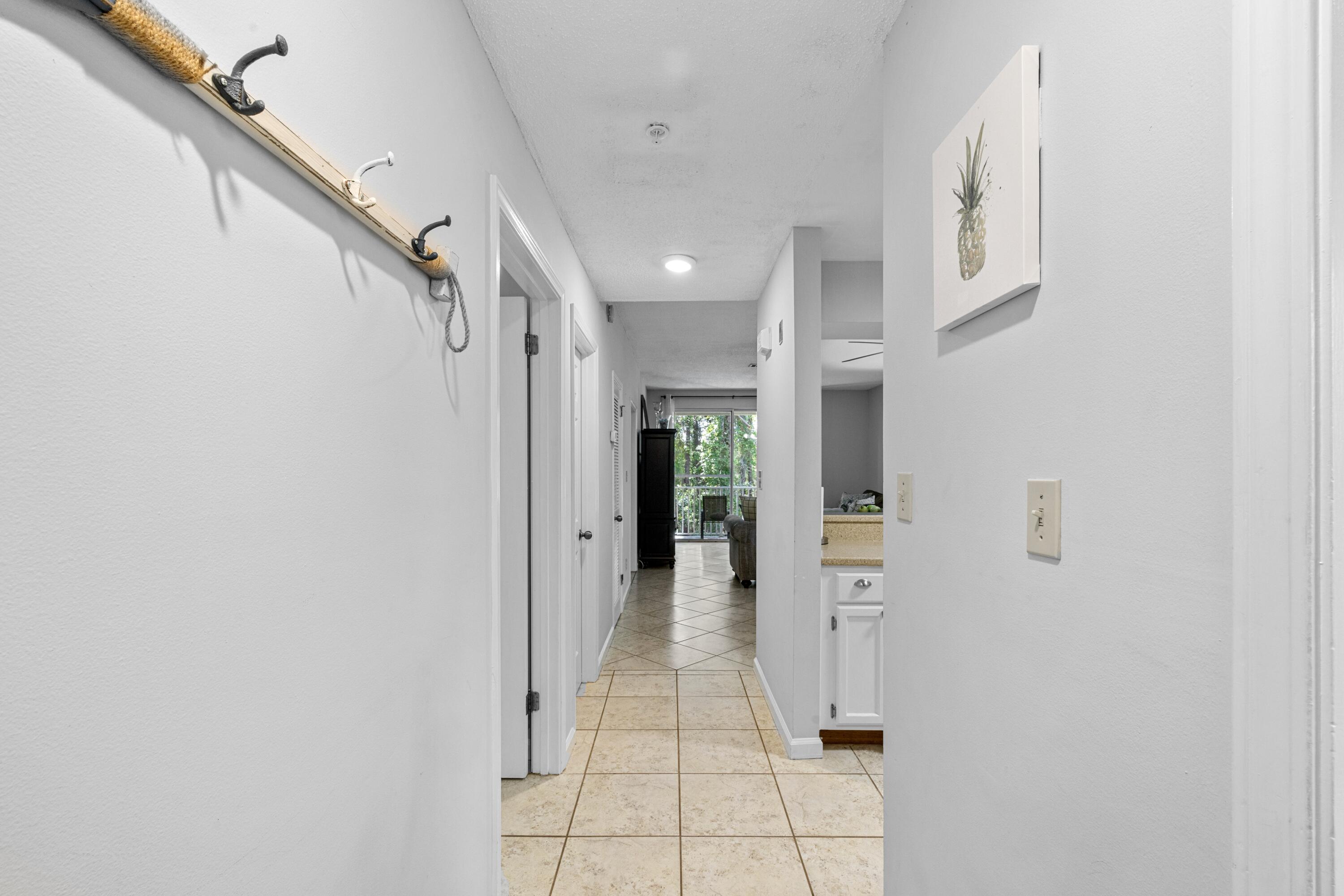 200 Sandestin Lane, Unit 1209 Miramar Beach, FL 32550 - Photo 2 of 30 a view of a hallway with wooden floor and staircase