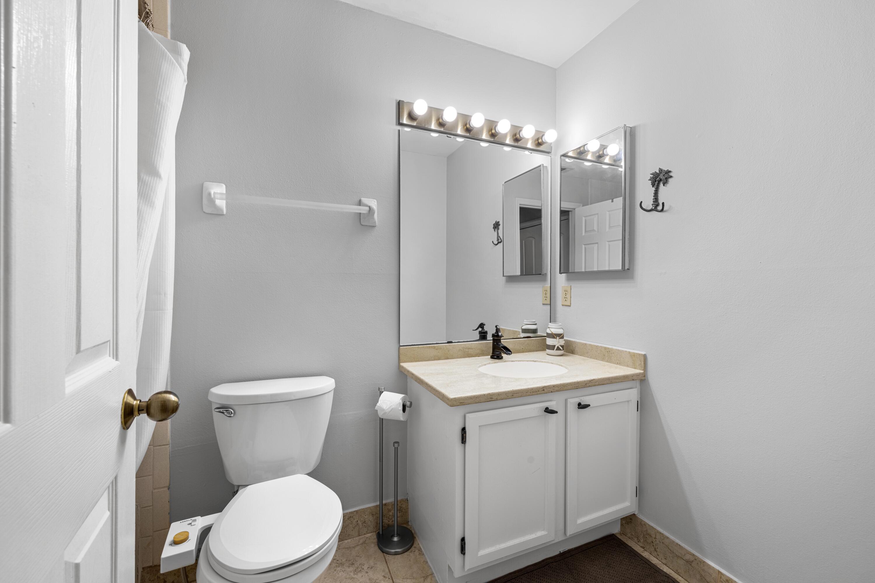 200 Sandestin Lane, Unit 1209 Miramar Beach, FL 32550 - Photo 23 of 30 a bathroom with a toilet sink and mirror