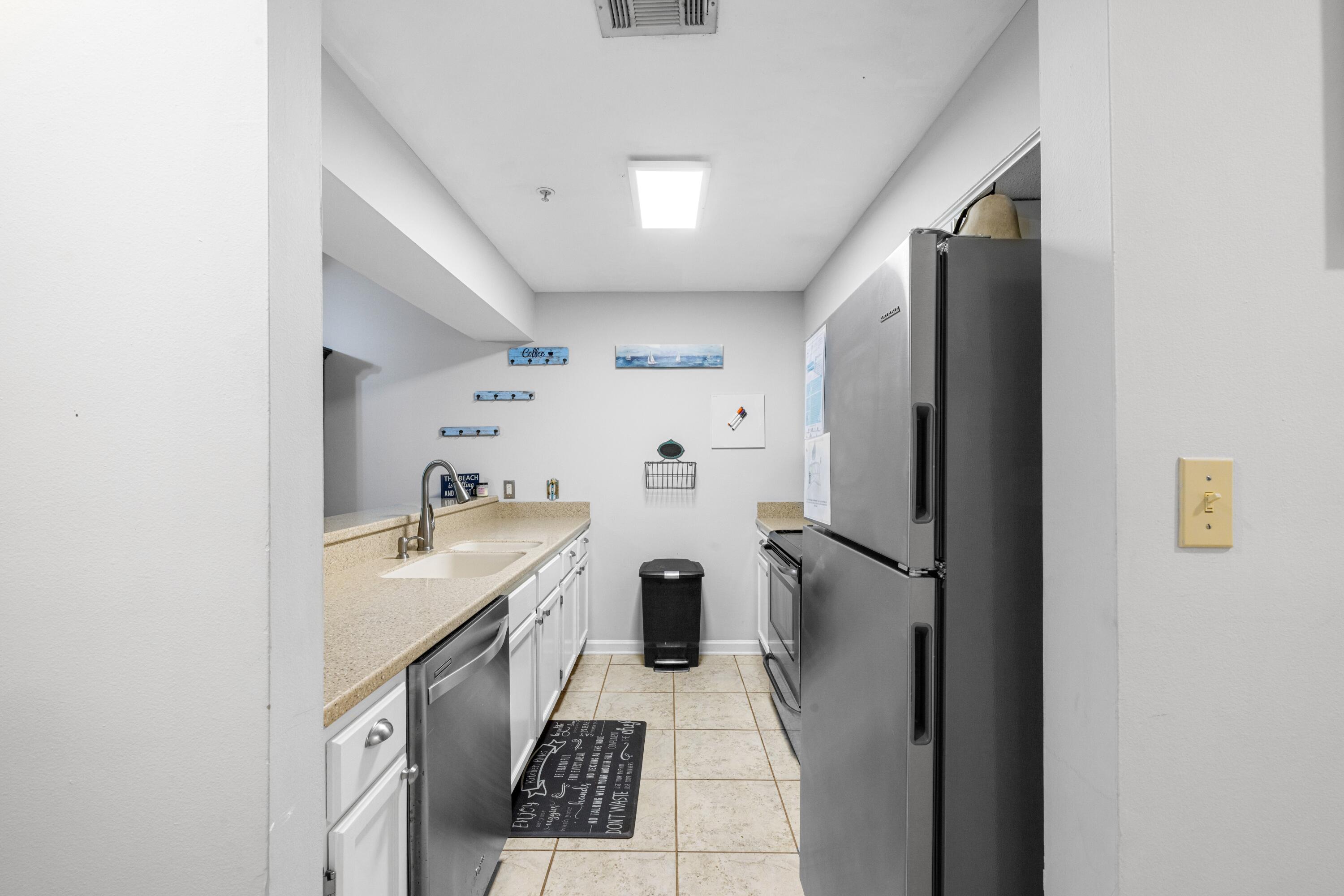 200 Sandestin Lane, Unit 1209 Miramar Beach, FL 32550 - Photo 3 of 30 a kitchen with a sink appliances and cabinets