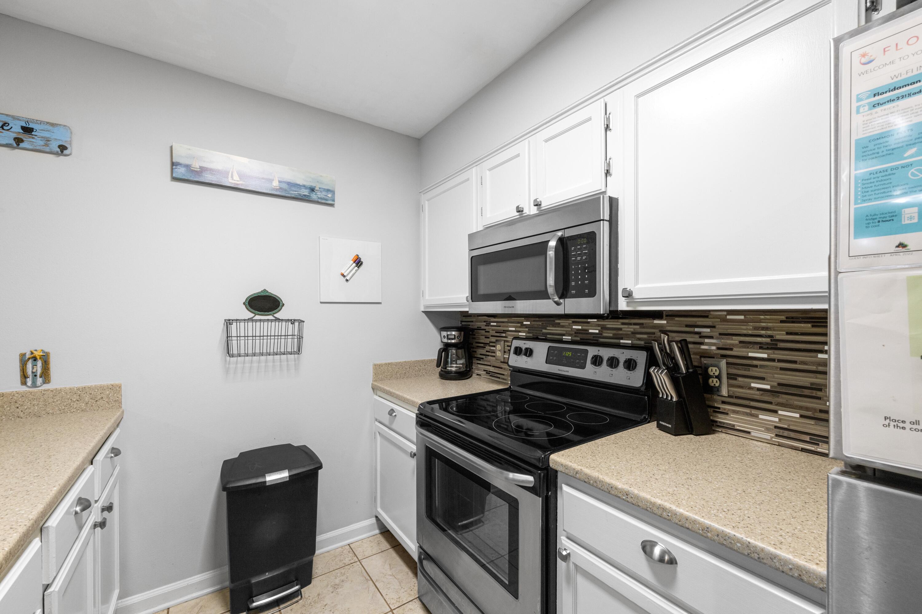 200 Sandestin Lane, Unit 1209 Miramar Beach, FL 32550 - Photo 4 of 30 a kitchen with a stove and a microwave