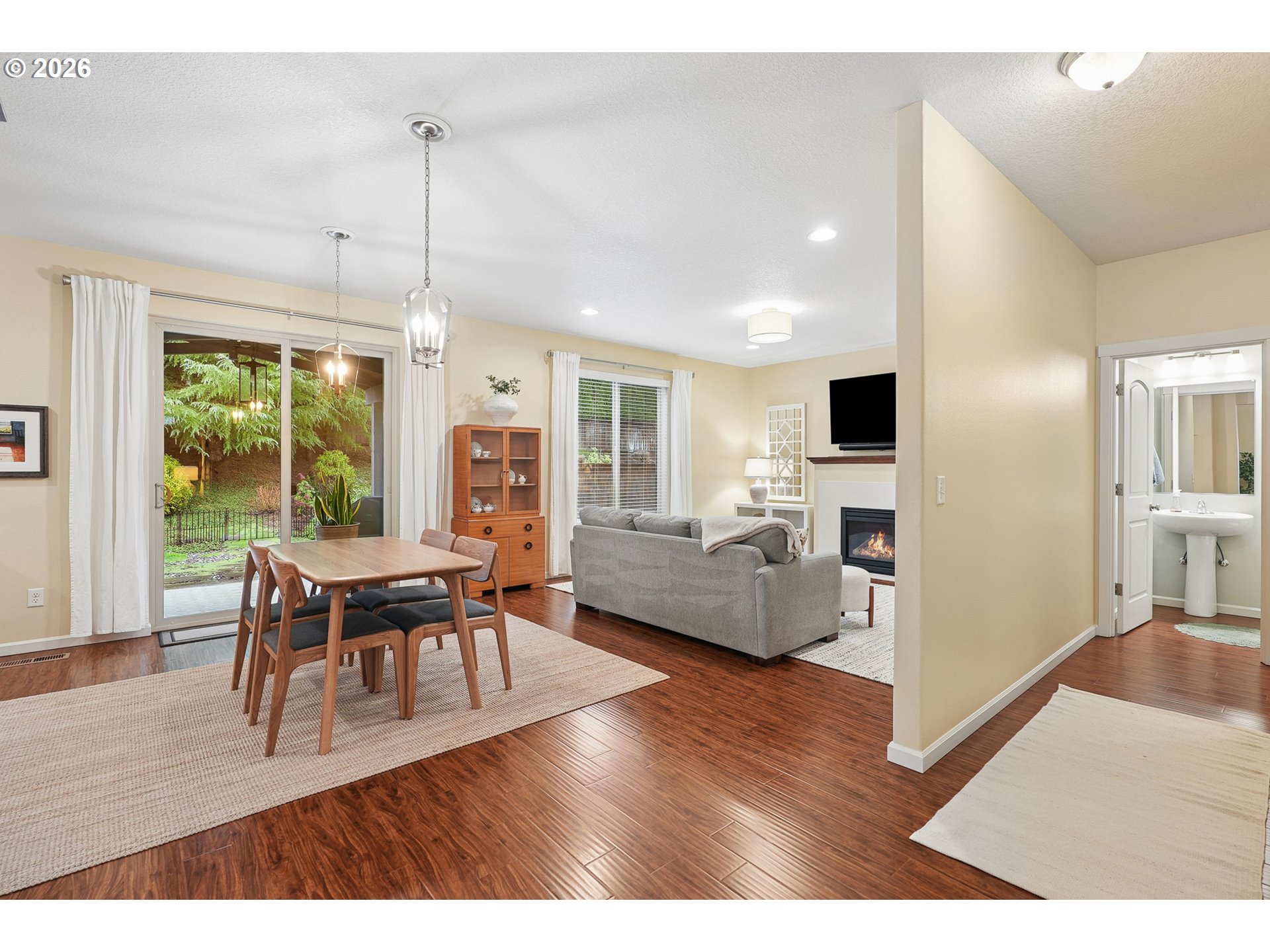 504 North Allen Creek Drive Ridgefield, WA 98642 - Photo 11 of 38 a living room with furniture a wooden floor and a kitchen view