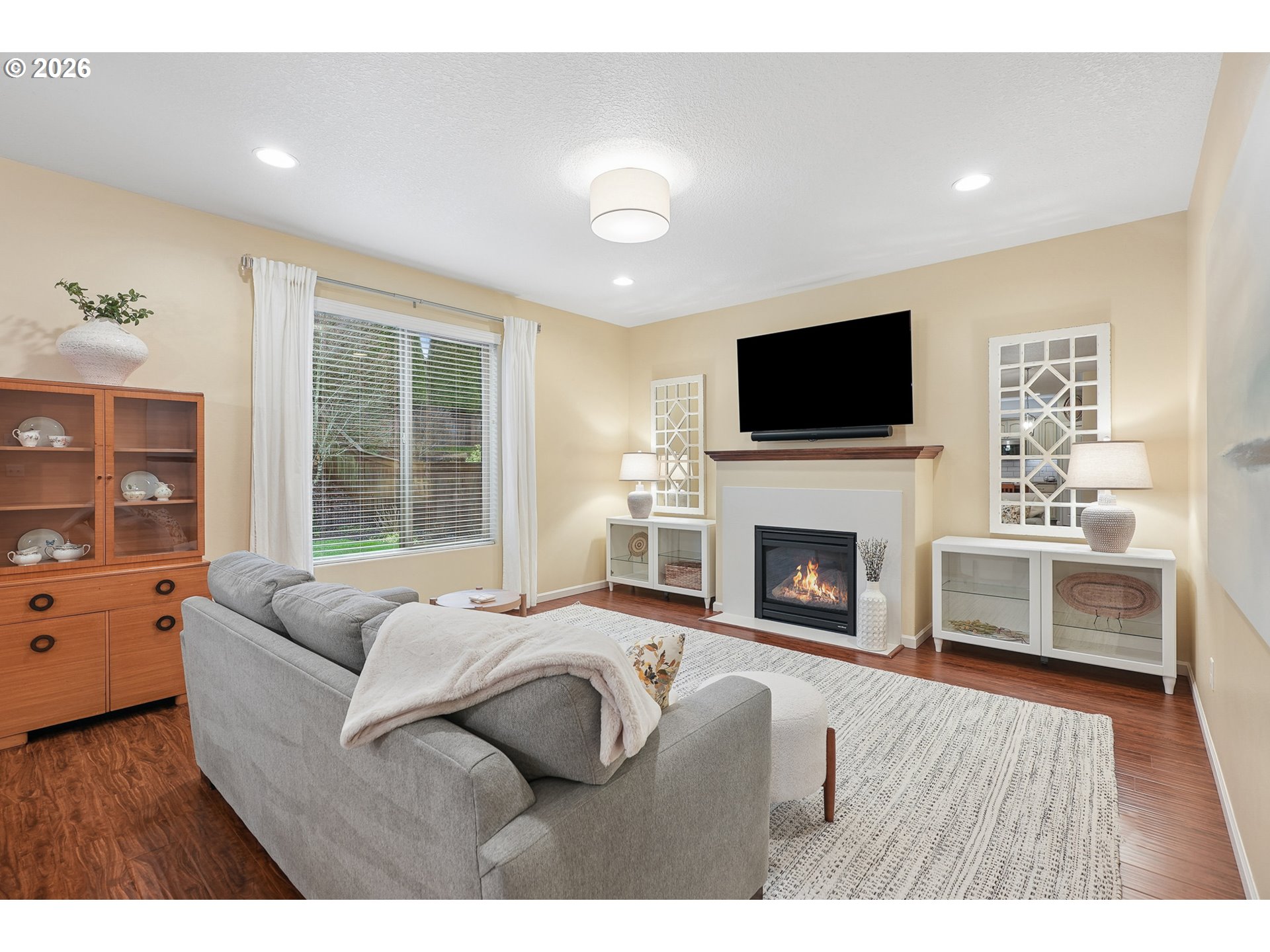 504 North Allen Creek Drive Ridgefield, WA 98642 - Photo 12 of 38 a living room with furniture a fireplace and a flat screen tv
