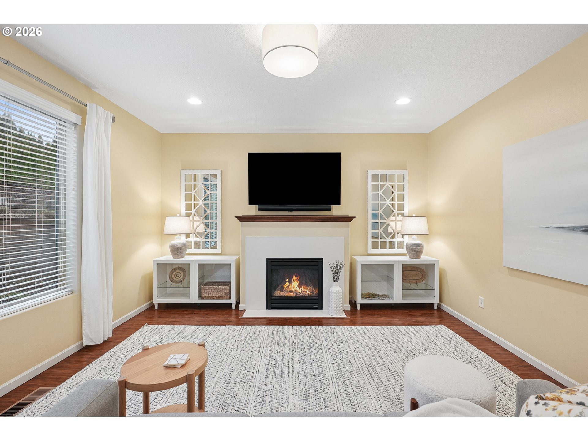 504 North Allen Creek Drive Ridgefield, WA 98642 - Photo 13 of 38 a living room with furniture a fireplace and a flat screen tv