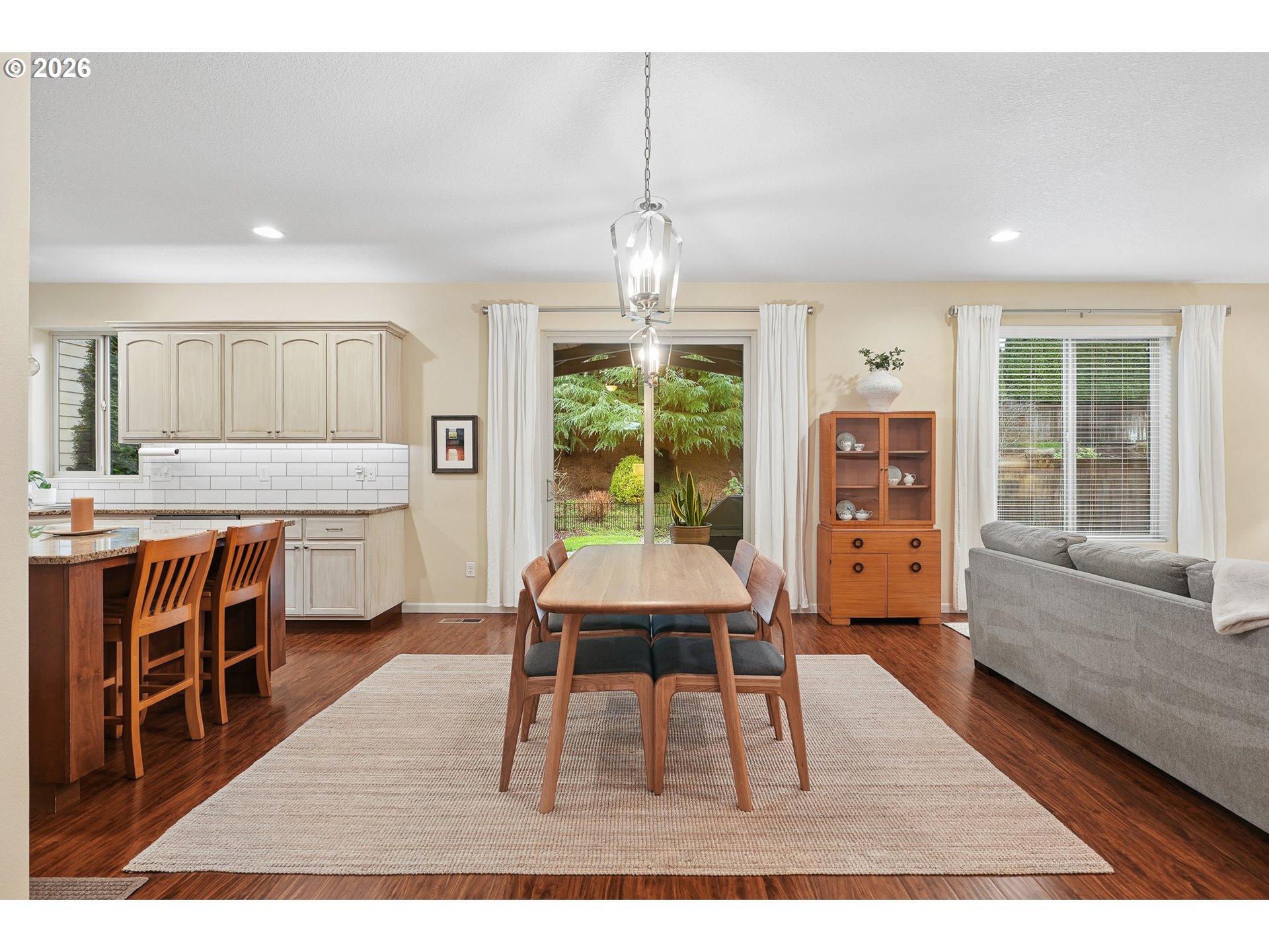 504 North Allen Creek Drive Ridgefield, WA 98642 - Photo 14 of 38 a living room with stainless steel appliances granite countertop furniture wooden floor and a chandelier