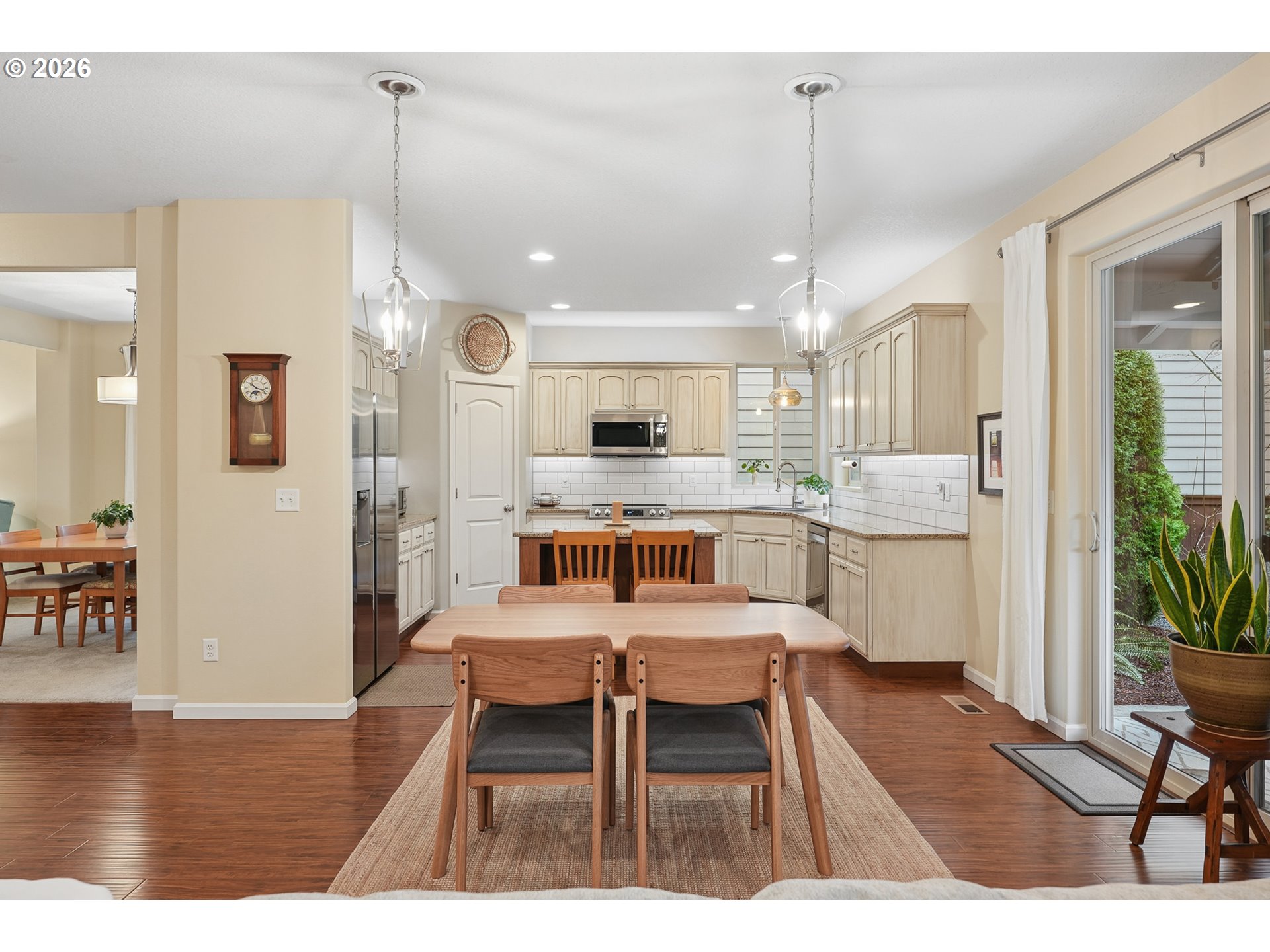504 North Allen Creek Drive Ridgefield, WA 98642 - Photo 16 of 38 a open kitchen with stainless steel appliances kitchen island granite countertop a dining table chairs and white cabinets