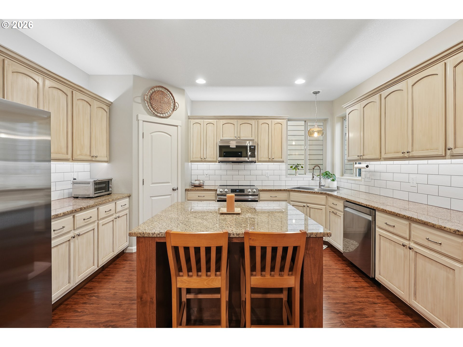 504 North Allen Creek Drive Ridgefield, WA 98642 - Photo 17 of 38 a kitchen with stainless steel appliances granite countertop a stove top oven a sink dishwasher and cabinets with wooden floor