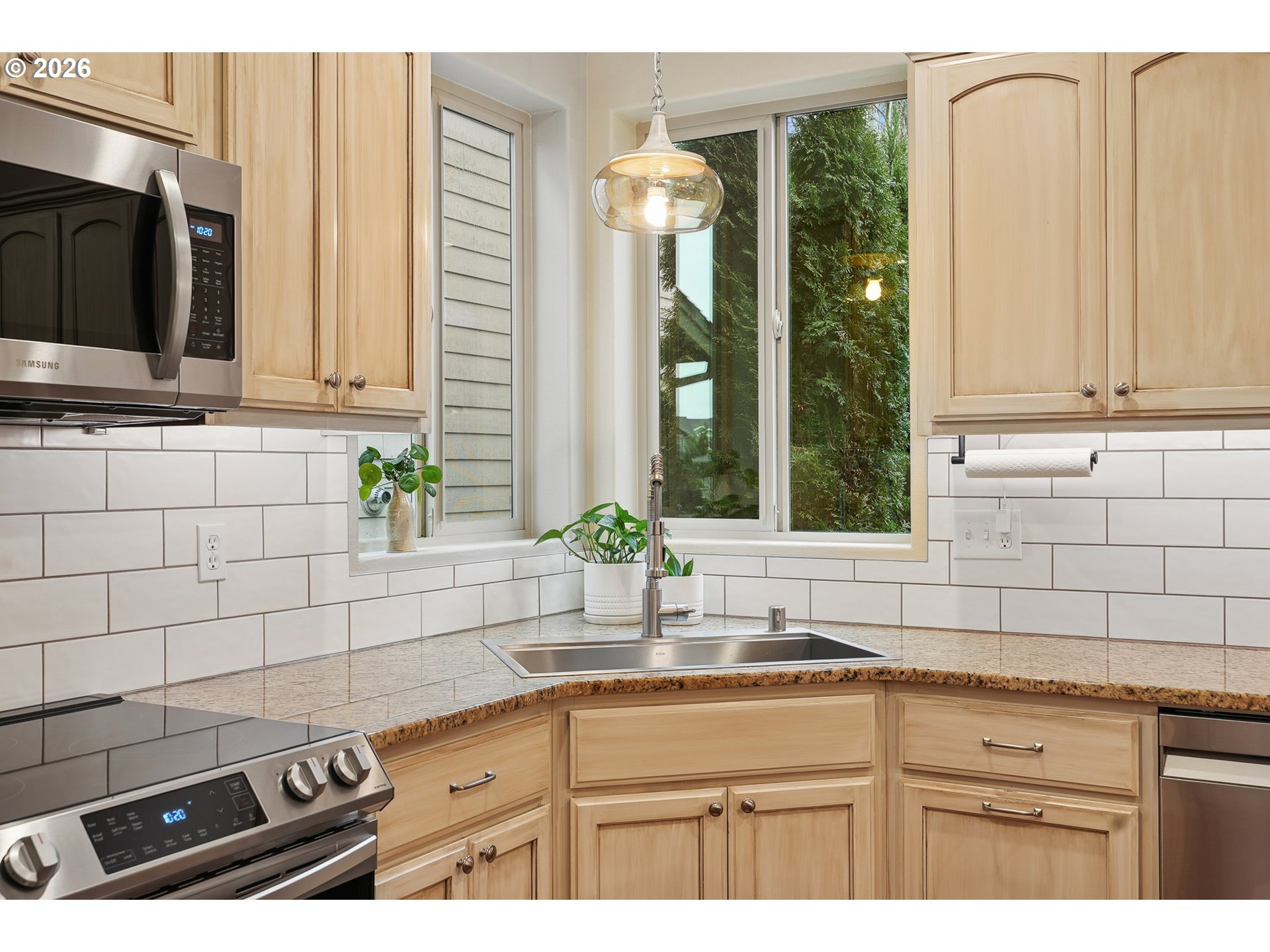 504 North Allen Creek Drive Ridgefield, WA 98642 - Photo 20 of 38 a kitchen with stainless steel appliances a sink a stove and a microwave