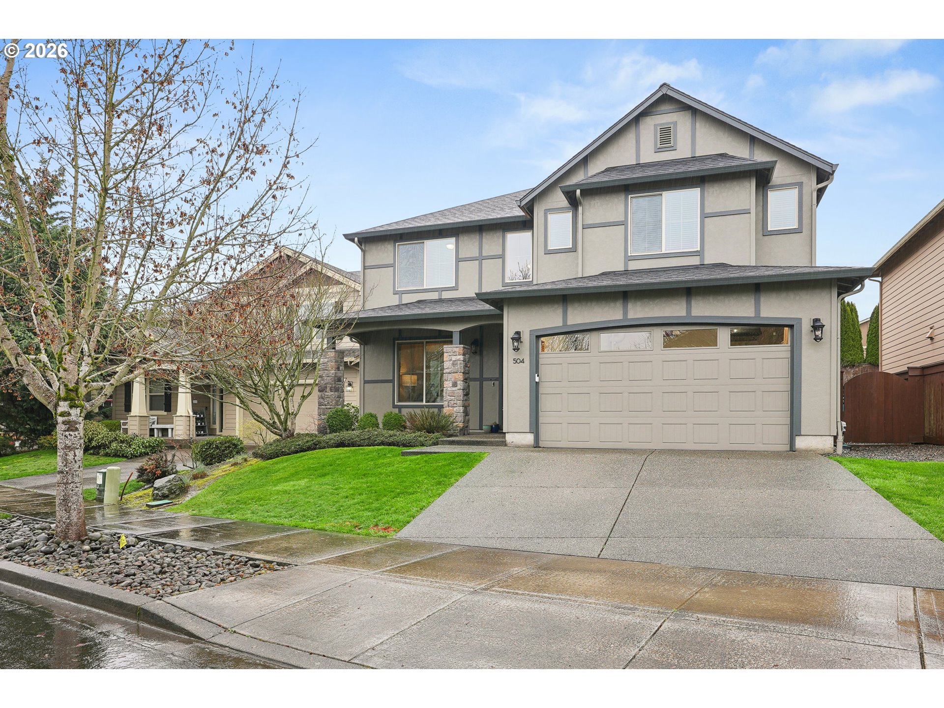 504 North Allen Creek Drive Ridgefield, WA 98642 - Photo 2 of 38 a front view of a house with a yard and garage