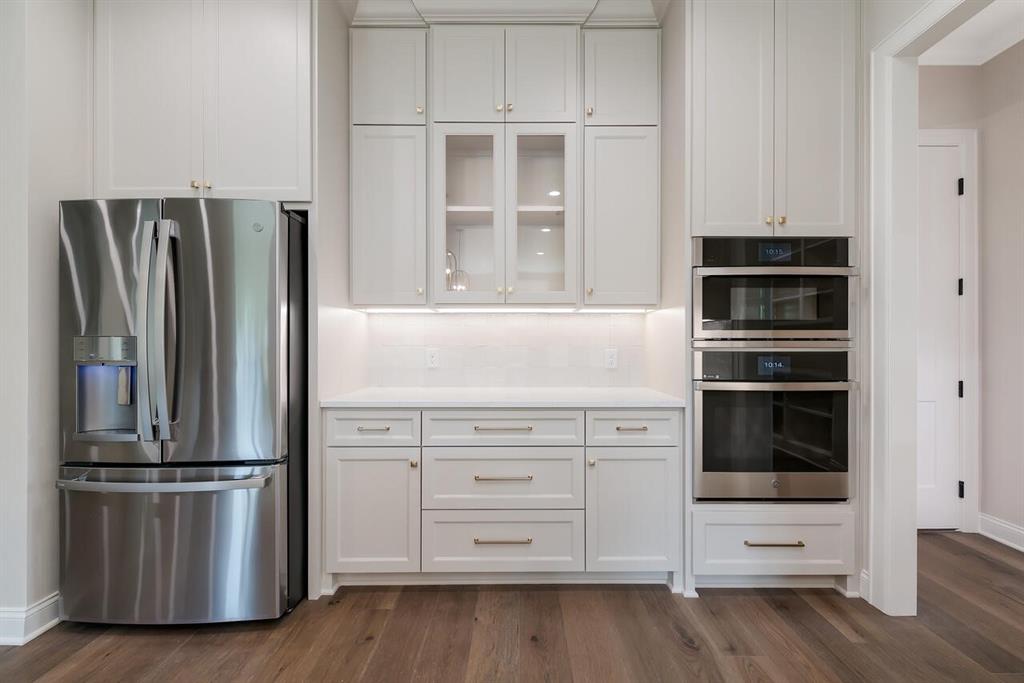 8005 Bee Cave Road China Spring, TX 76633 - Photo 17 of 40 Kitchen featuring stainless steel appliances, white cabinetry, and dark wood-style floors