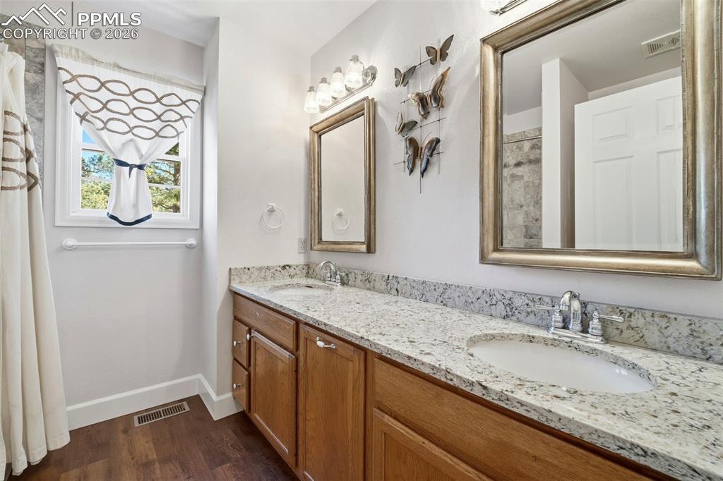 8795 Moss Rock Road Colorado Springs, CO 80908 - Photo 30 of 47 Full Guest Bath with Tub/Shower Combo and Dual Vanity