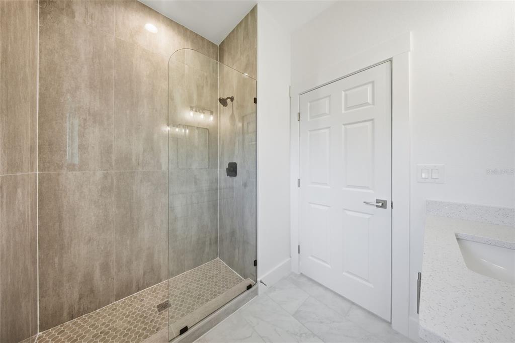 10458 Pendleton Avenue Englewood, FL 34224 - Photo 13 of 30 a bathroom with a shower and a sink