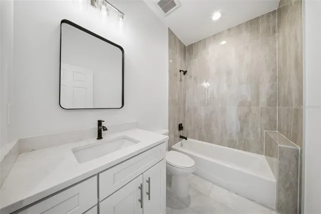 a bathroom with a sink a toilet and a bathtub