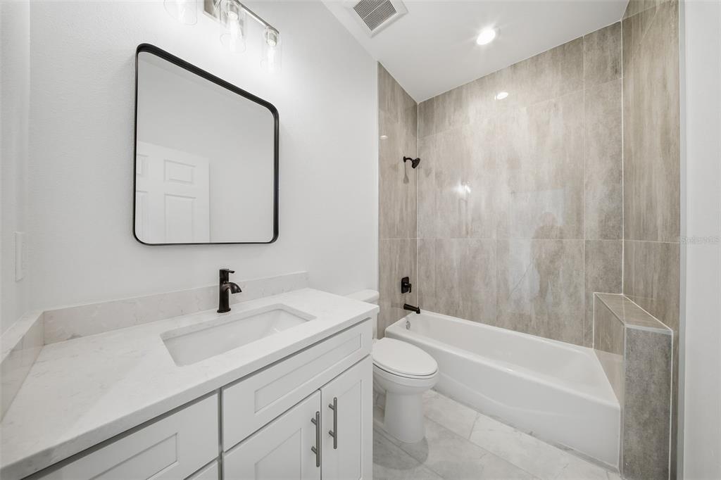 10458 Pendleton Avenue Englewood, FL 34224 - Photo 14 of 30 a bathroom with a sink a toilet and a bathtub