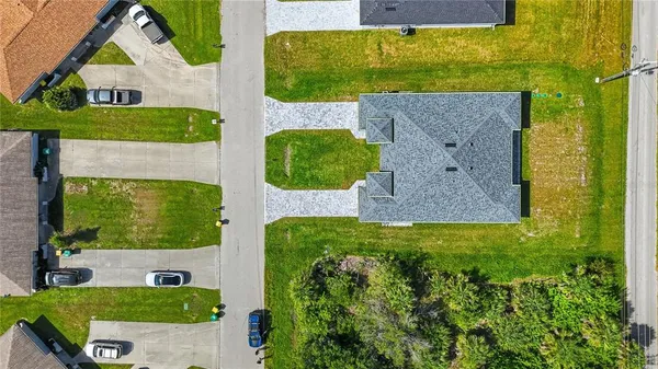 an aerial view of a house with a yard