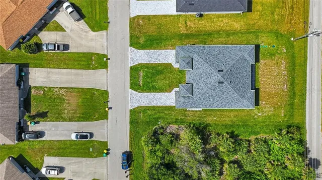 an aerial view of a house with a yard