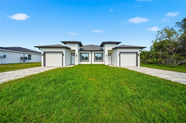 a front view of house with yard and green space