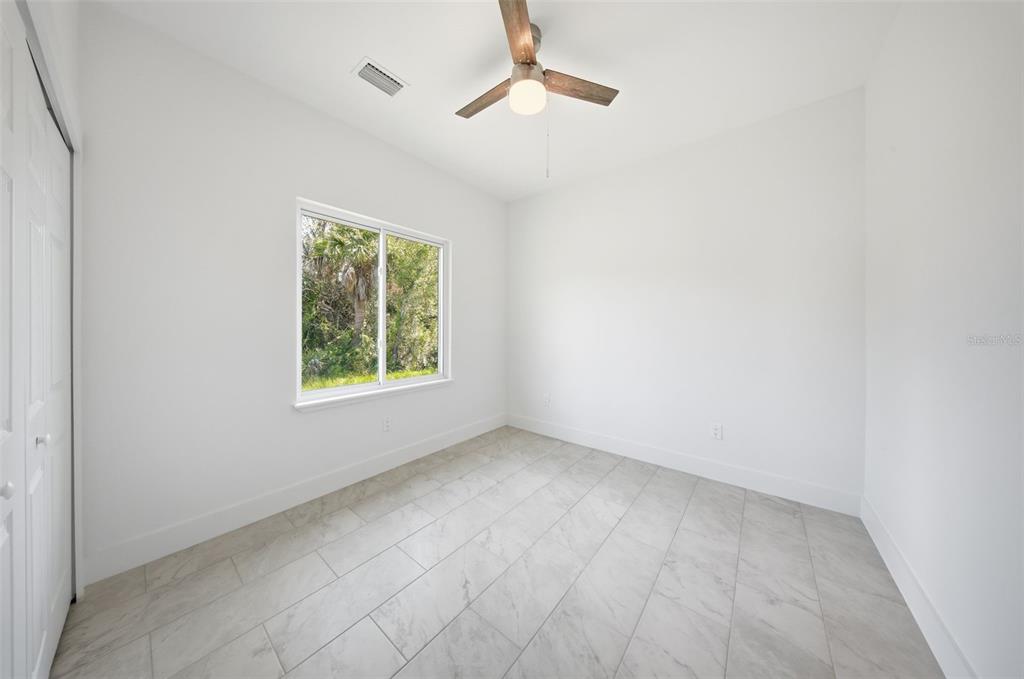 10458 Pendleton Avenue Englewood, FL 34224 - Photo 21 of 30 an empty room with windows