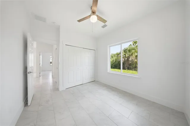 an empty room with windows and closet
