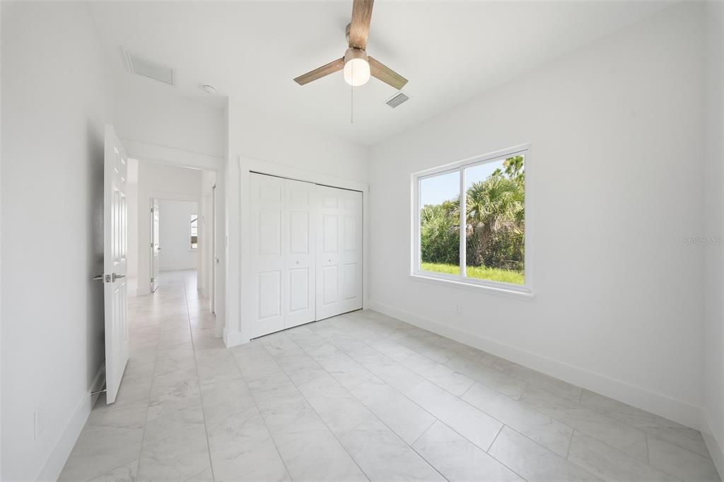 10458 Pendleton Avenue Englewood, FL 34224 - Photo 22 of 30 an empty room with windows and closet