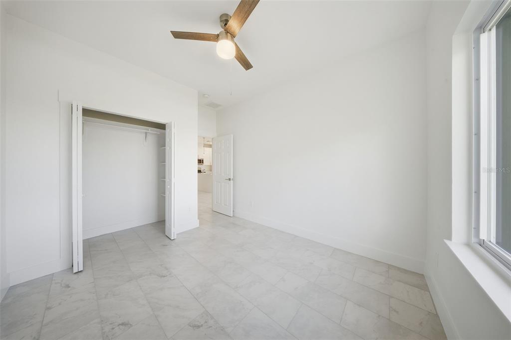10458 Pendleton Avenue Englewood, FL 34224 - Photo 24 of 30 an empty room with ceiling fan and window